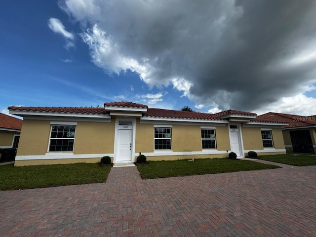 mediterranean / spanish-style home featuring a front lawn