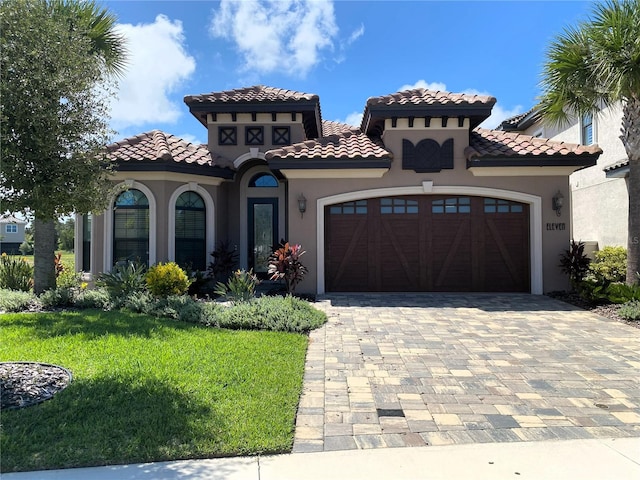 11 Rio Vista Dr, Palm Coast, FL 32137 - mediterranean / spanish-style house with a garage, decorative driveway, stucco siding, and a tile roof