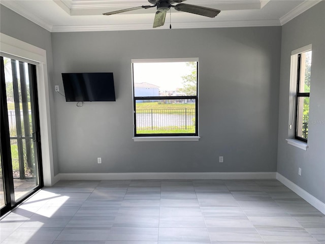 tiled spare room featuring ceiling fan, crown molding, and a wealth of natural light