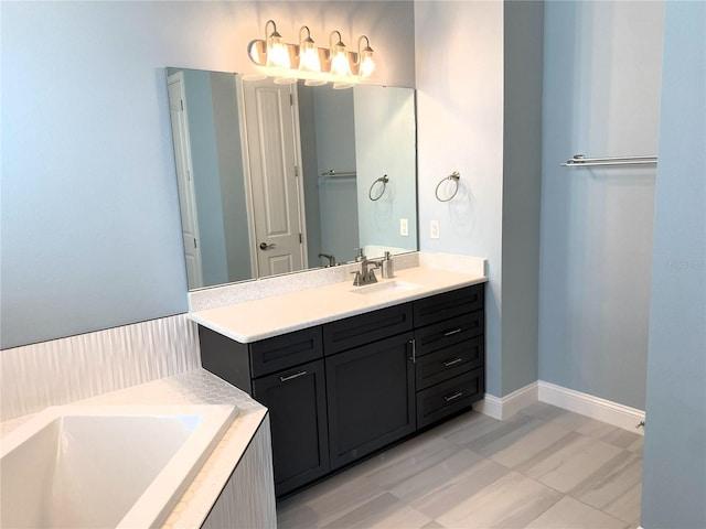 bathroom featuring tiled tub and vanity