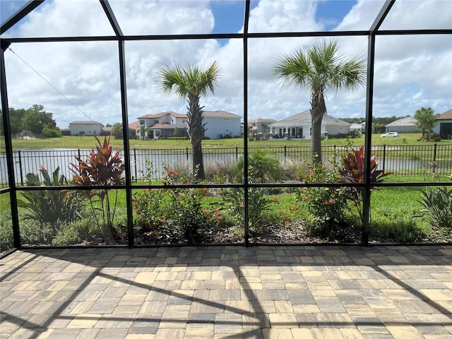 unfurnished sunroom with a water view