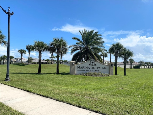 community sign featuring a lawn