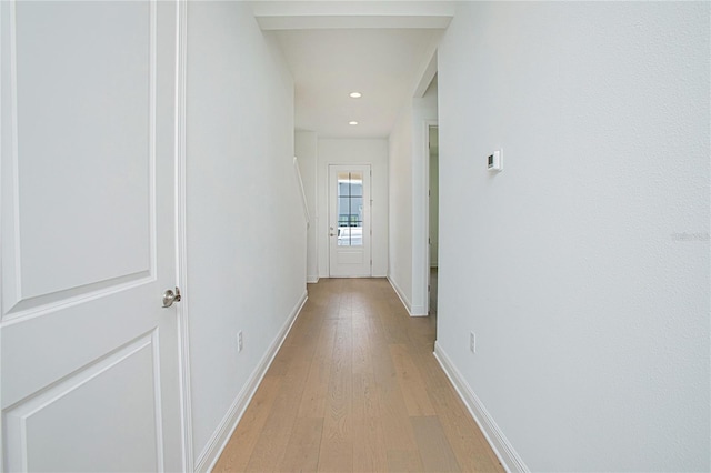 corridor with light hardwood / wood-style flooring