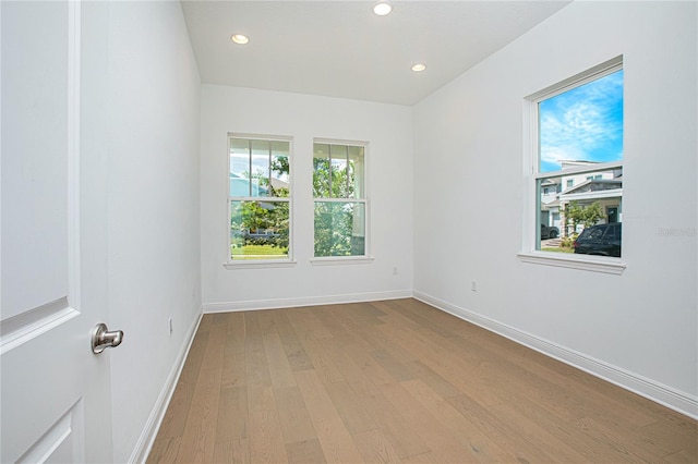 unfurnished room with light hardwood / wood-style floors