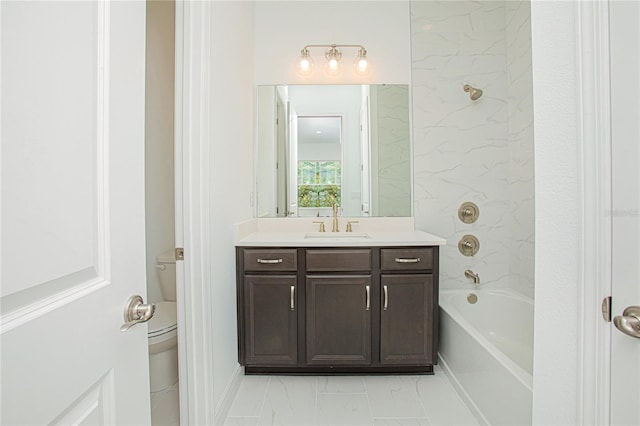 full bathroom featuring tiled shower / bath, vanity, and toilet