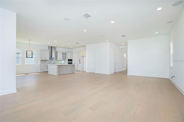 unfurnished living room with light hardwood / wood-style floors