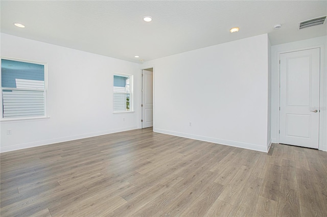 spare room featuring light wood-type flooring