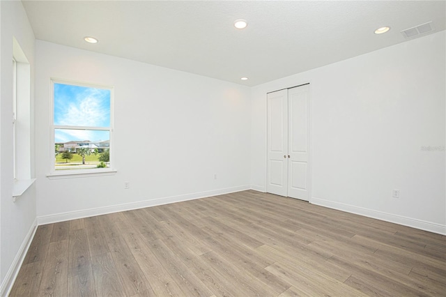 spare room with light hardwood / wood-style floors