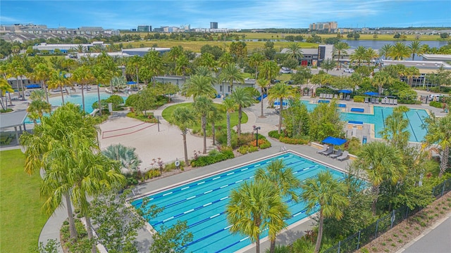 view of swimming pool with a water view and a patio area