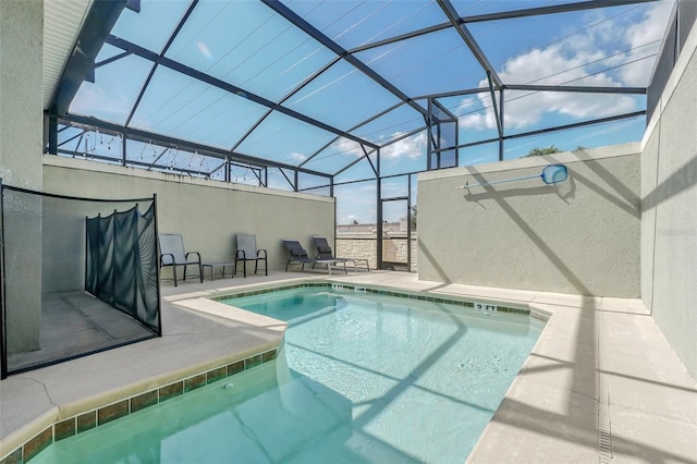 view of swimming pool featuring a lanai and a patio