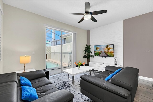 living room with light hardwood / wood-style floors and ceiling fan