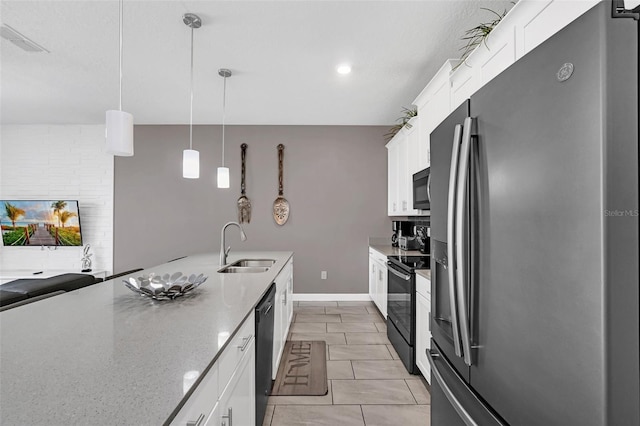 kitchen featuring light stone counters, white cabinets, hanging light fixtures, and black appliances