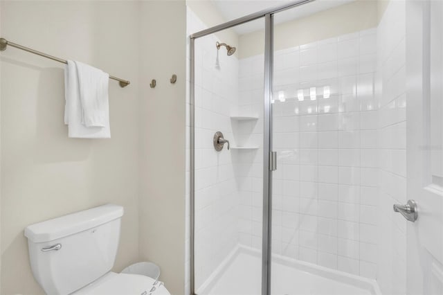 bathroom with walk in shower and toilet