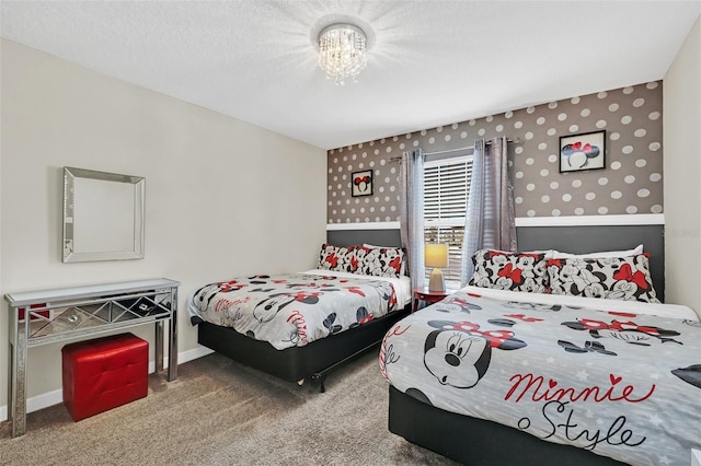 carpeted bedroom with a notable chandelier and a textured ceiling