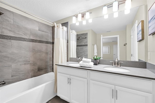 bathroom featuring shower / bath combo, a textured ceiling, and vanity