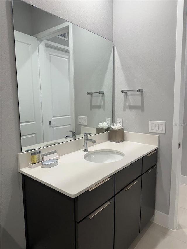 bathroom with vanity and tile patterned flooring