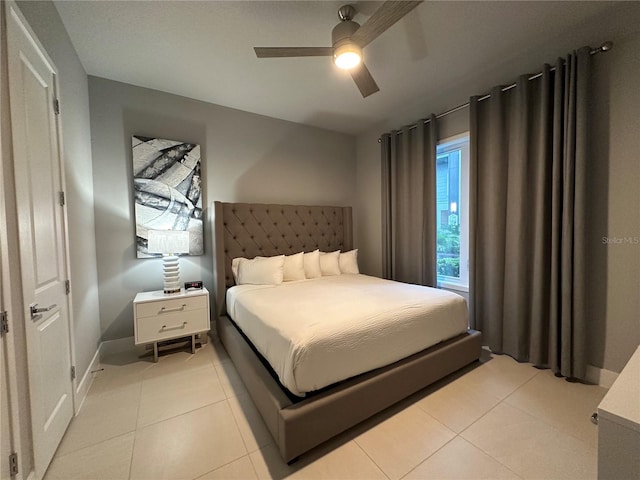 bedroom with ceiling fan and light tile patterned flooring