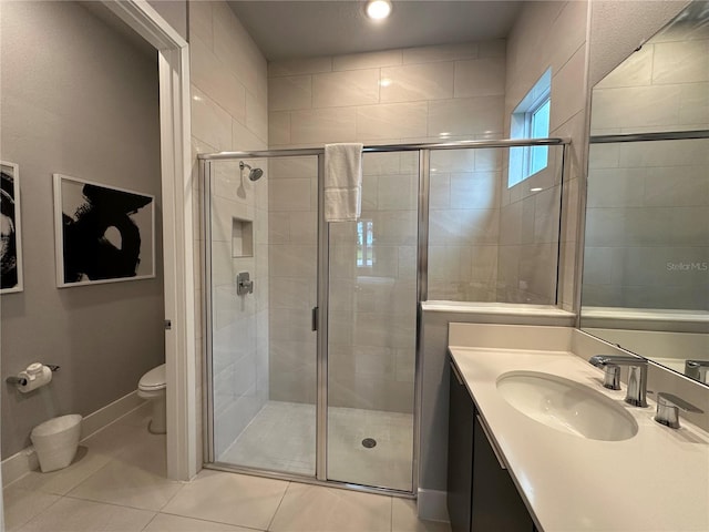 bathroom with vanity, toilet, an enclosed shower, and tile patterned floors