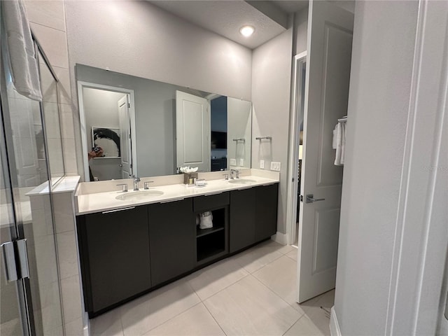 bathroom with tile patterned flooring, vanity, and an enclosed shower