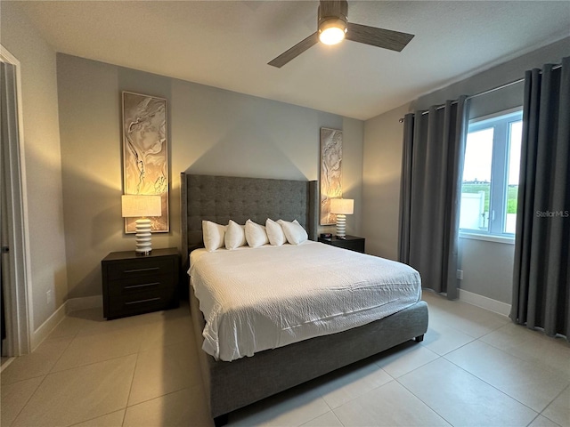 bedroom featuring light tile patterned flooring and ceiling fan