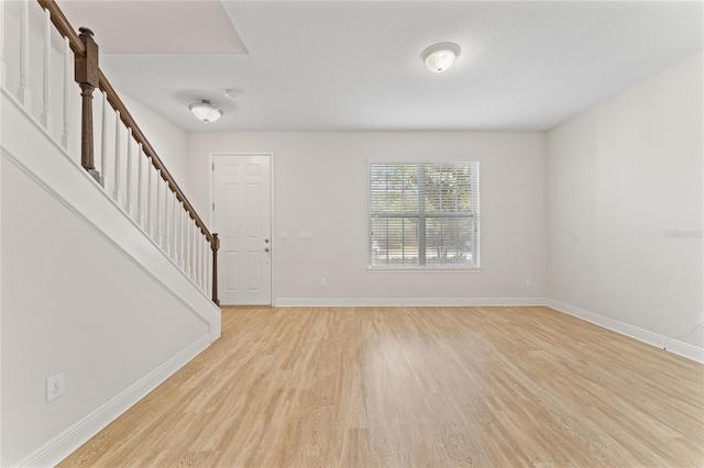 foyer featuring light wood-type flooring and a barn door