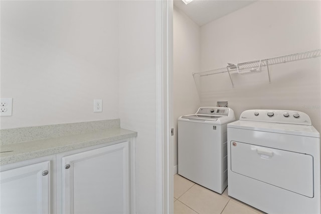 washroom with light tile patterned flooring and washer and clothes dryer