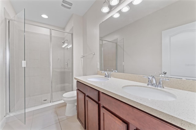 bathroom with vanity, toilet, an enclosed shower, and tile patterned floors