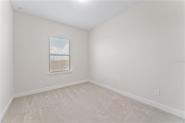 unfurnished room with light carpet