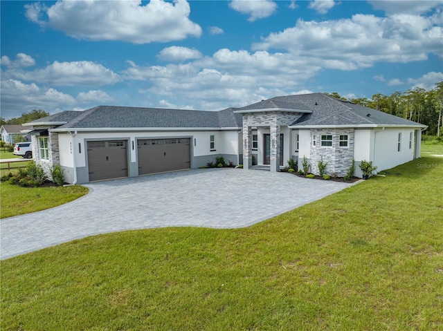 prairie-style house featuring a garage and a front lawn