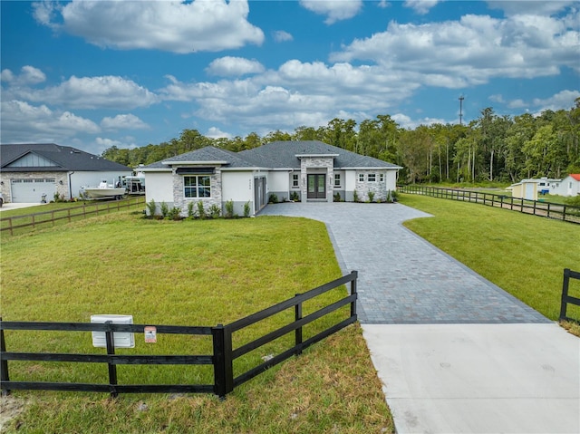 ranch-style home with a garage and a front lawn