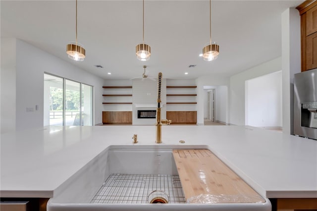 kitchen with ceiling fan and hanging light fixtures