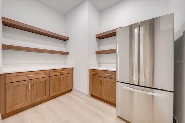 kitchen featuring stainless steel refrigerator and light wood-type flooring