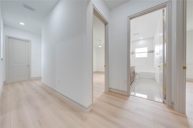 corridor featuring light hardwood / wood-style floors