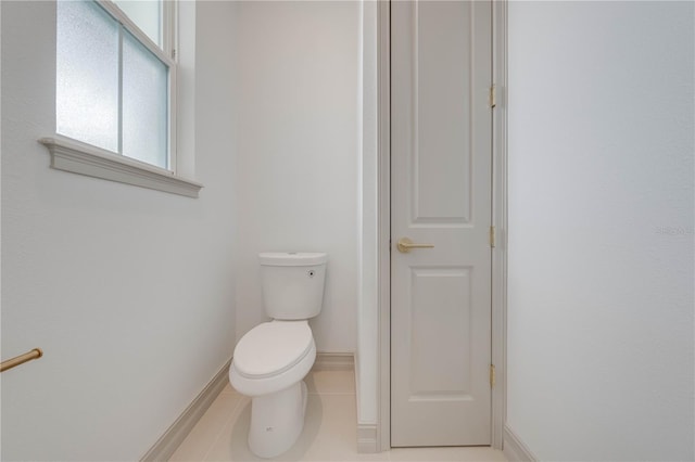 bathroom with toilet and tile patterned floors