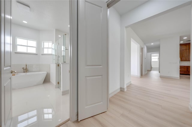 bathroom with shower with separate bathtub and hardwood / wood-style floors