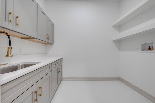 kitchen featuring gray cabinets and sink