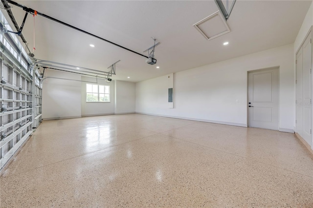 garage featuring electric panel and a garage door opener