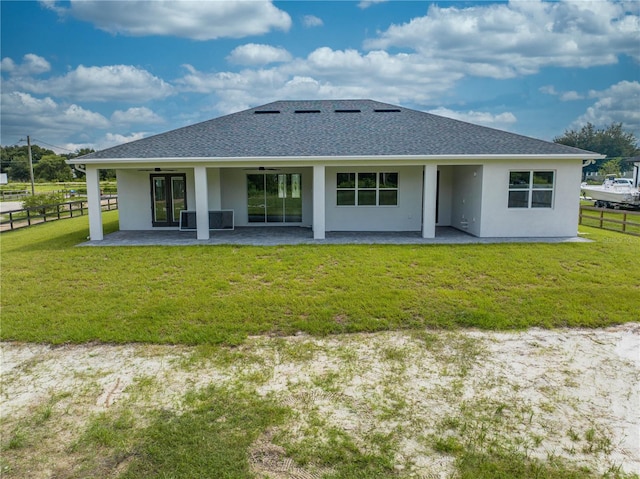 back of property featuring a yard and a patio