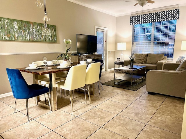 dining space with ceiling fan, light tile patterned flooring, and crown molding