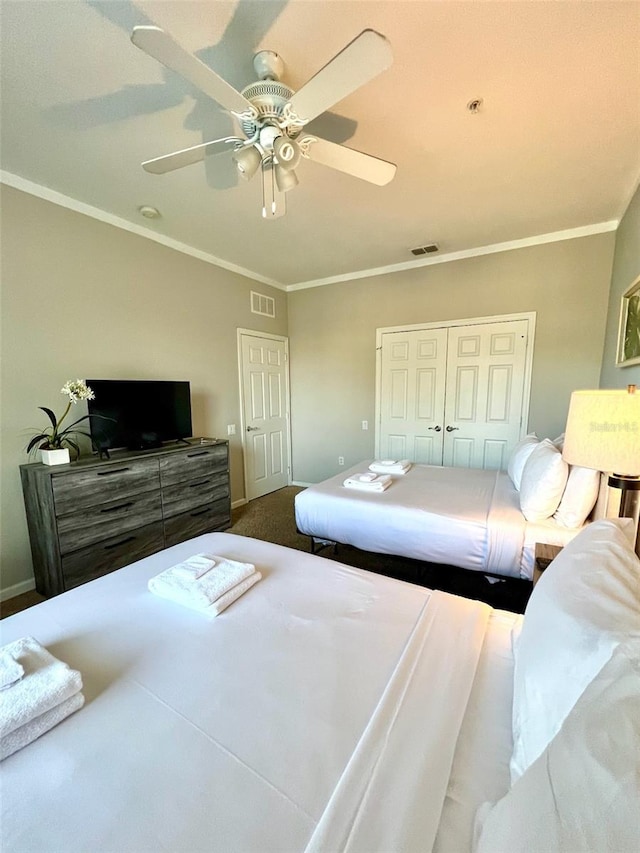 bedroom featuring ceiling fan, a closet, and crown molding