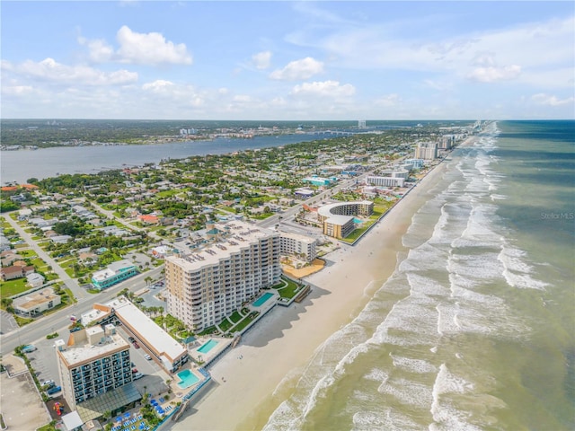 aerial view featuring a city view, a view of the beach, and a water view