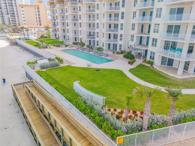 exterior space with a lawn, a pool, and fence