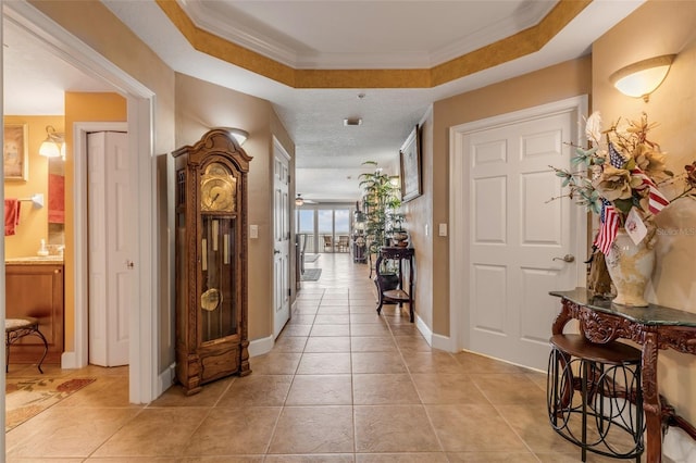 interior space with baseboards, light tile patterned flooring, and ornamental molding