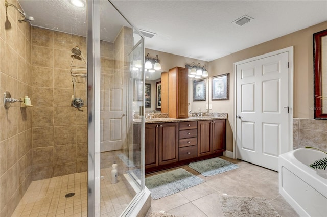 full bath featuring visible vents, double vanity, a stall shower, a garden tub, and tile patterned floors