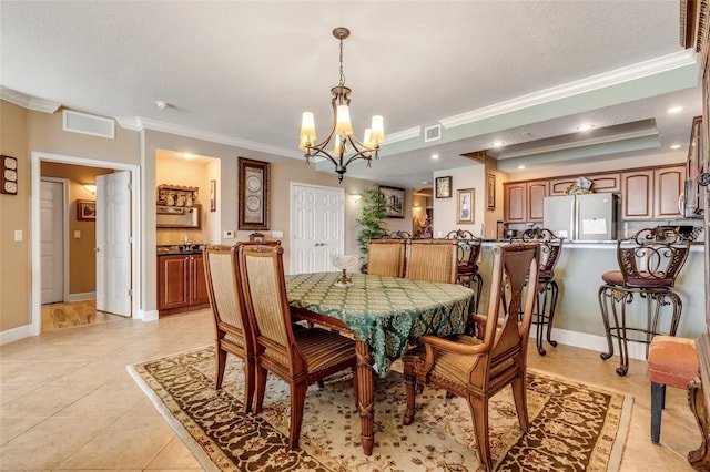 dining space featuring light tile patterned floors, visible vents, crown molding, and baseboards