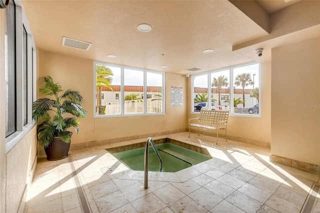 view of swimming pool featuring an indoor hot tub