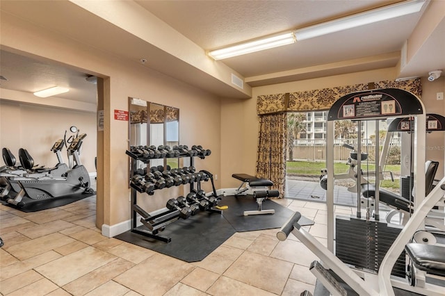 gym with baseboards and visible vents