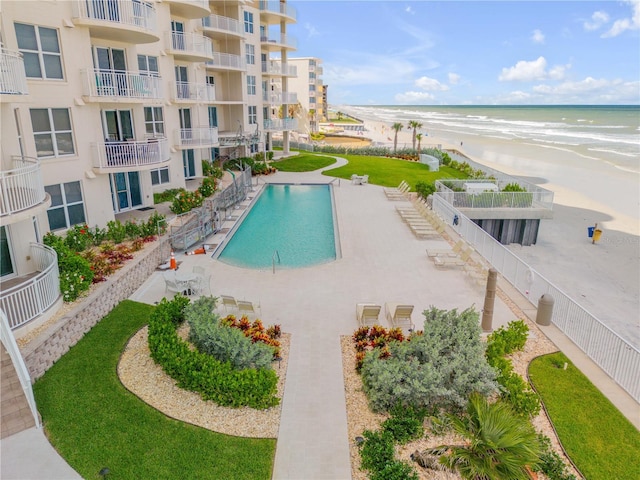 view of pool featuring a beach view and a water view