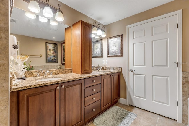 full bathroom with tile patterned floors, double vanity, and a sink