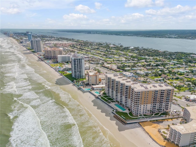 birds eye view of property featuring a view of the beach, a view of city, and a water view